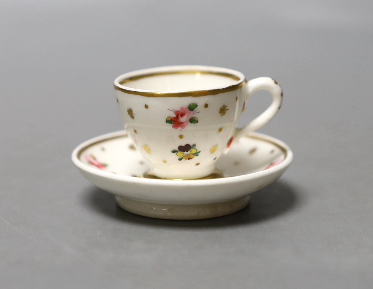 Chamberlain's miniature cup and saucer painted with flowers c.1820 - 4cm high